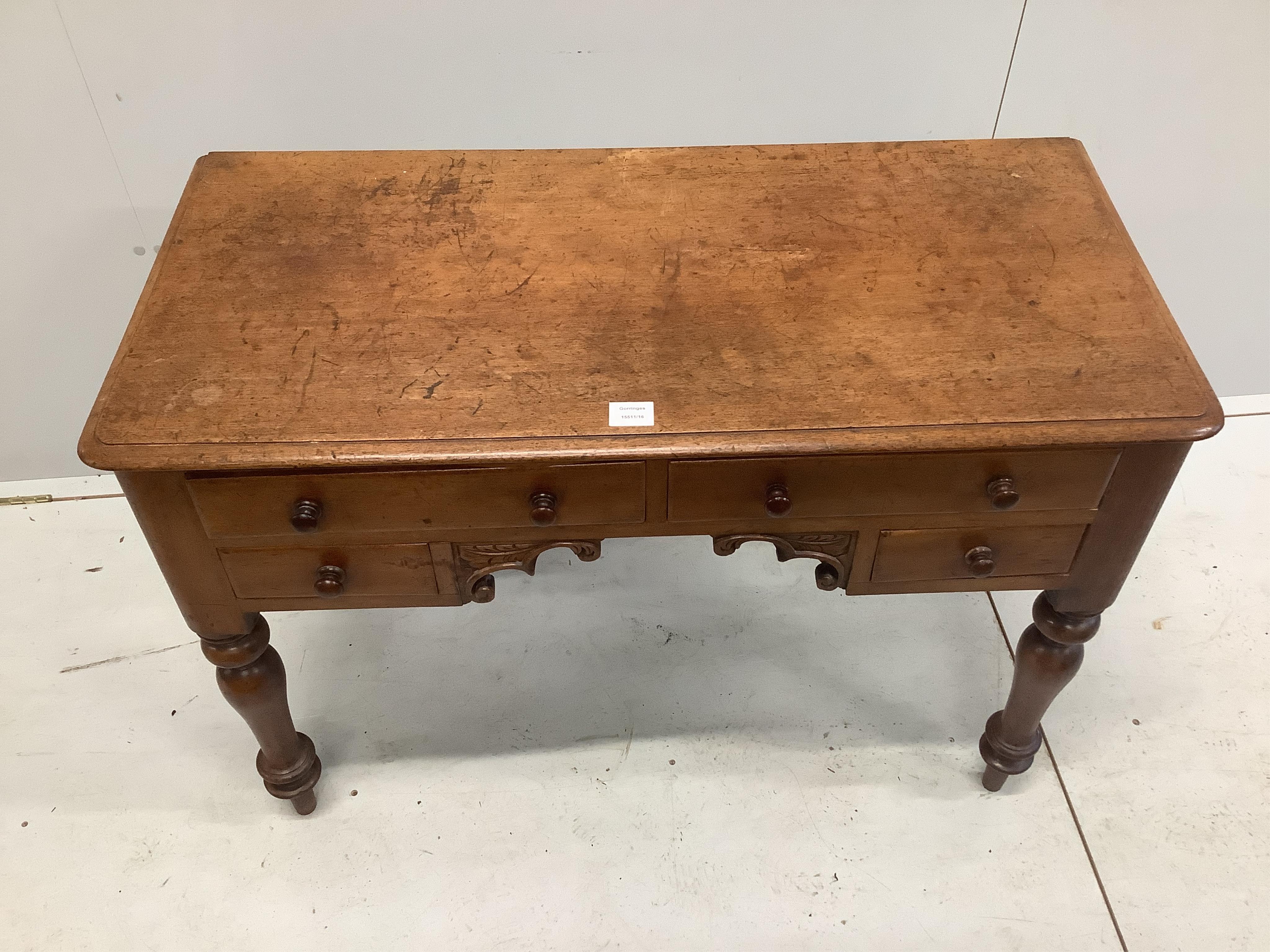 A Victorian mahogany kneehole dressing table, fitted four small drawers, width 101cm, depth 49cm, height 72cm. Condition - fair